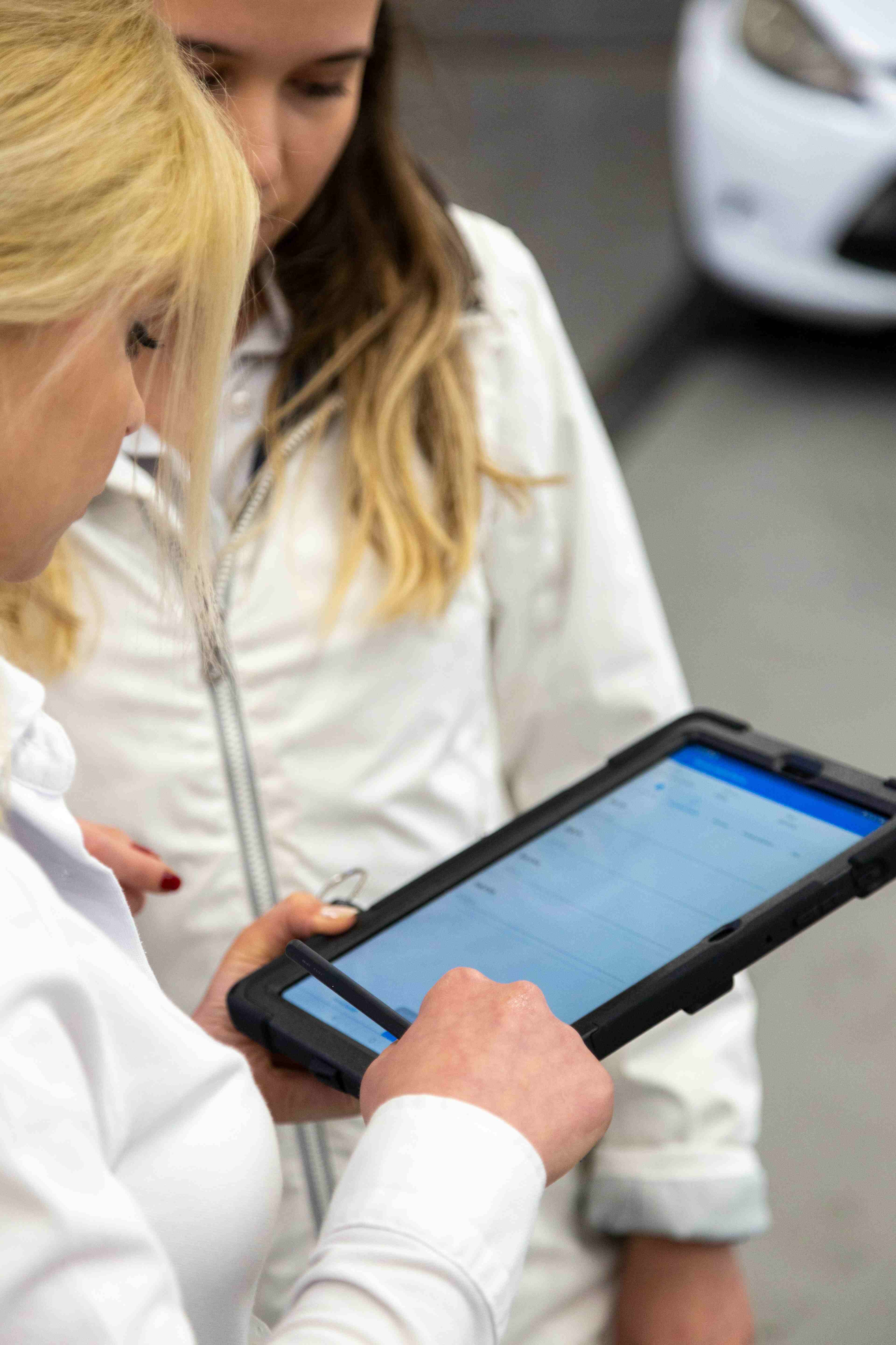 Clinician using a tablet in a hospital corridor